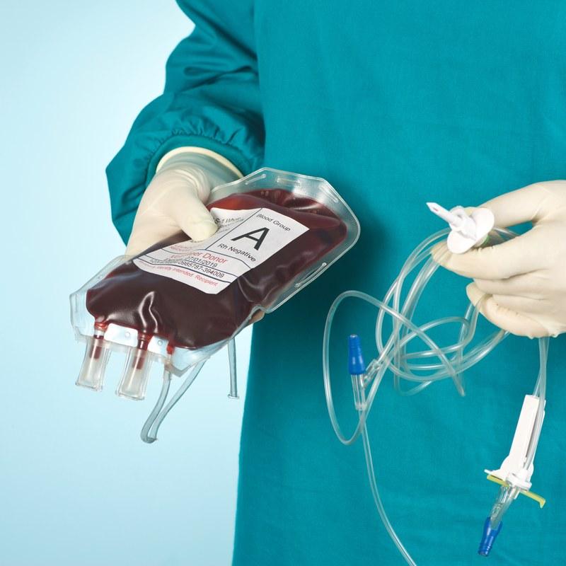 Surgeon holding a blood transfusion bag
