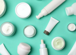 Personal care cream jars and tubes on a teal background